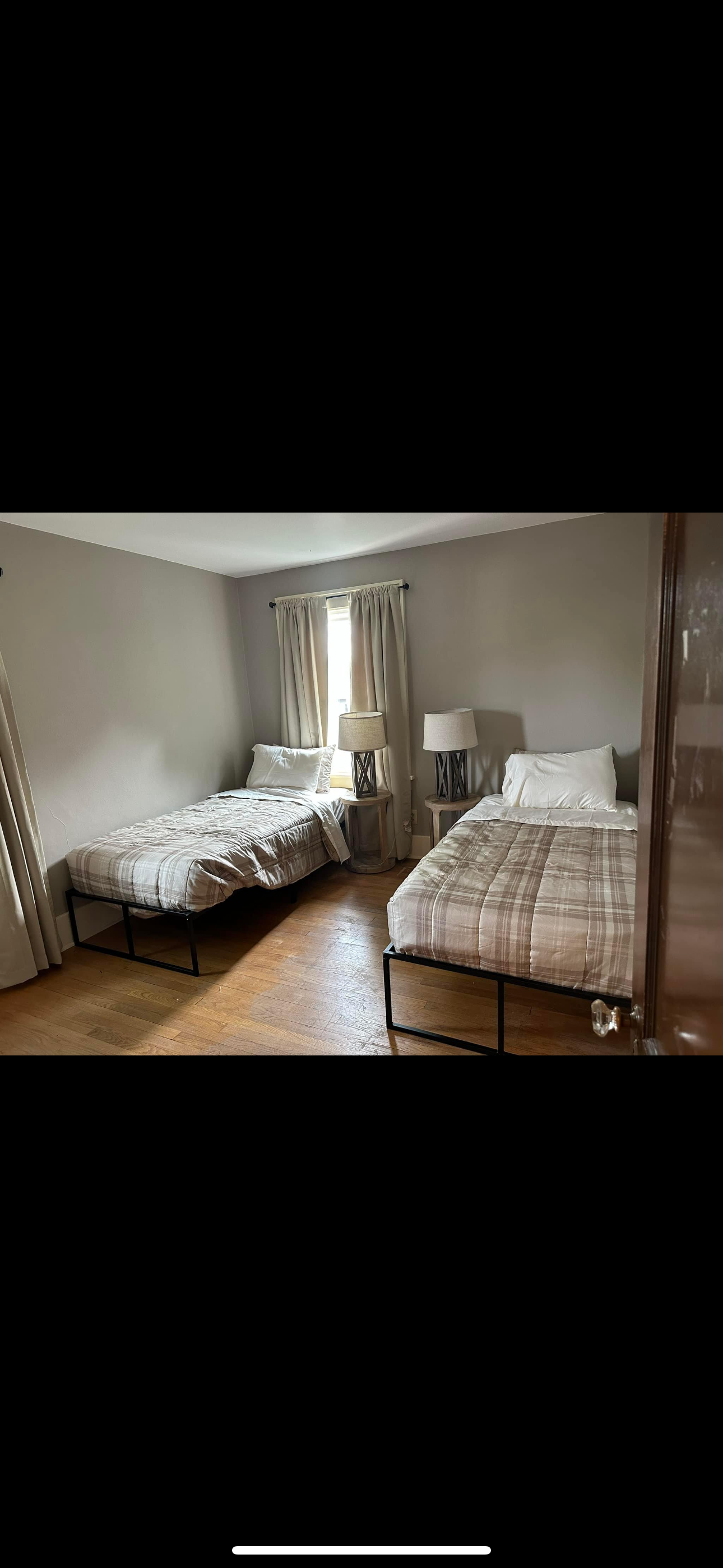 Shared bedroom with two beds and natural light